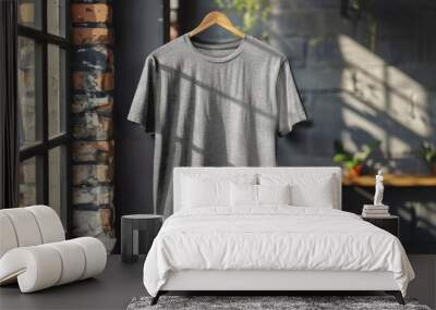 Gray t-shirt hanging on wooden hanger in loft interior Wall mural