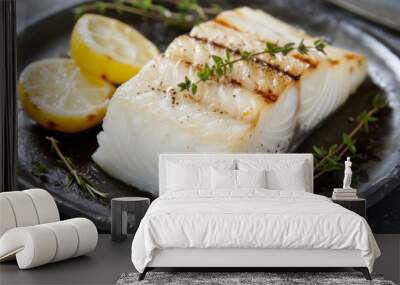 Grilled cod fish steak with thyme and lemon on a dark plate, ready to be served Wall mural