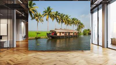 Houseboat traveling canals in Kerala India with palm trees lining waters edge Wall mural