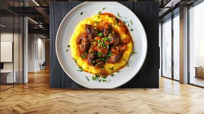 Meat and sauce stew with polenta and parsley garnish served on a white plate Wall mural