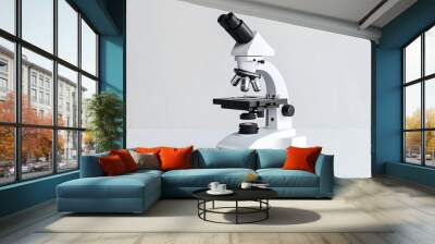 Modern white microscope on a white background with space for text, representing scientific research and innovation Wall mural