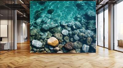 Ocean or sea shore with stones in blue water Wall mural