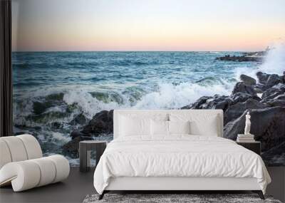 Sea waves in sunset with rocks and stones. Nature landscape. Wall mural