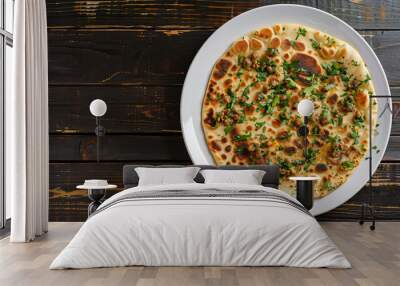 Savory keema paratha topped with fresh cilantro presented on a white plate on a rustic wooden table Wall mural