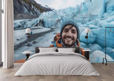 Smiling man taking a selfie in front of a glacier Wall mural