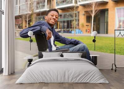 a happy young man in a wheelchair. Wall mural