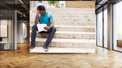 young man reading a letter in the street Wall mural