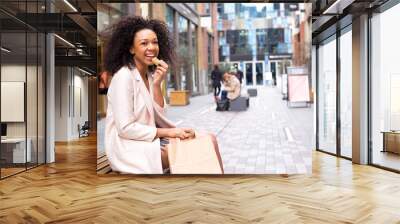 young woman having a healthy snack in the street Wall mural