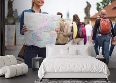 young woman in Prague on holiday holding a map Wall mural