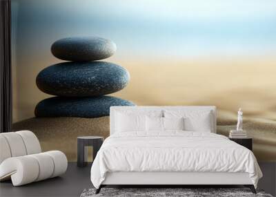 Stack of smooth grey stones is balancing on a beach with an out of focus background Wall mural