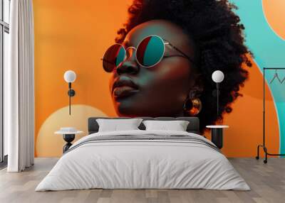 Stylish african woman with trendy sunglasses posing against a vibrant orange and blue background Wall mural