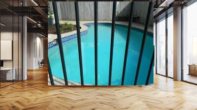 Swimming pool behind safety fence Wall mural