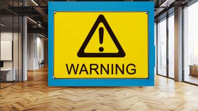 Closeup view of street warning exclamation sign on yellow metallic board Wall mural