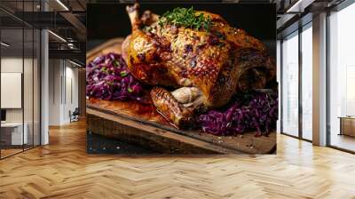 Whole roasted goose served on a rustic wooden board with red cabbage and fresh herbs Wall mural