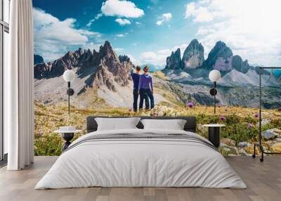 Young athletic couple enjoys summit of Sasso di Sesto in the afternoon. Tre Cime, Dolomites, South Tirol, Italy, Europe. Wall mural