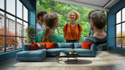 Young woman tour guide talking to group of tourists in forest Wall mural