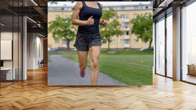 Unidentified woman wearing tank top and shorts Wall mural