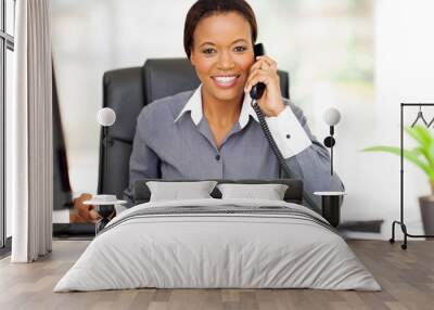 african american businesswoman using landline phone Wall mural