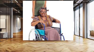 african daughter pushing senior mother on wheelchair Wall mural