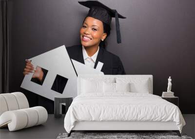 african female university graduate holding paper house Wall mural