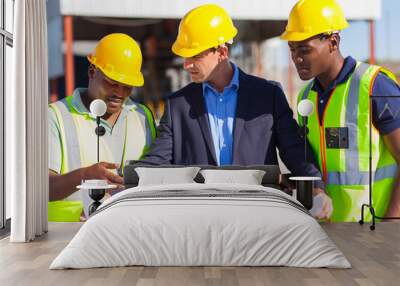 architect and construction workers on construction site Wall mural