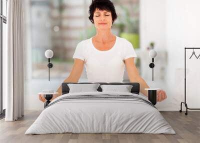 beautiful middle aged woman meditation on bed at home Wall mural