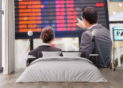 businessman and businesswoman checking flight information Wall mural