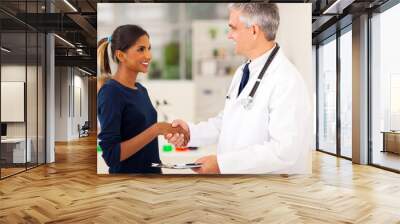 doctor handshaking with young patient Wall mural