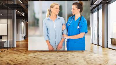 female medical doctor talking to senior patient Wall mural