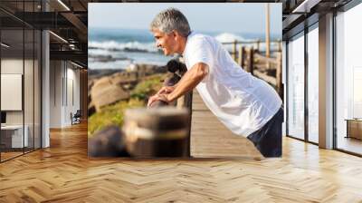 fit senior man exercising at the beach Wall mural