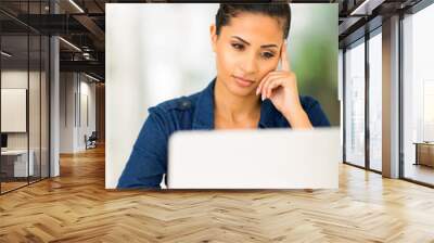 focused young woman using laptop computer Wall mural