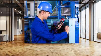 industrial technician examining control box Wall mural