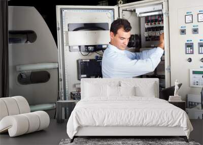 industrial technician repairing modern computerized machine Wall mural