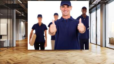 IT technician giving two thumbs up in front of colleagues Wall mural