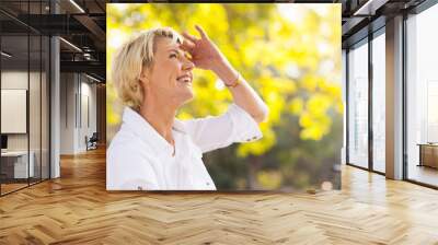 mature woman looking up Wall mural