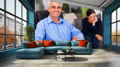 middle aged male psychologist in office Wall mural