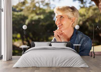 middle aged woman sitting at the park Wall mural