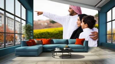 muslim family outside their home pointing Wall mural