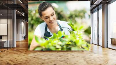 pretty young woman gardening Wall mural