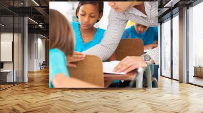 primary school educator helping a student in class Wall mural