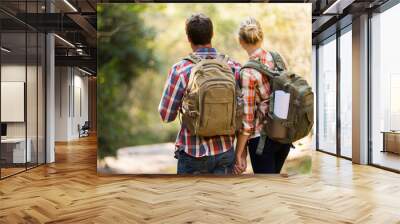 rear view of young couple hiking in mountain Wall mural