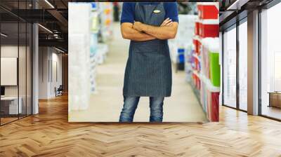 supermarket worker with arms crossed Wall mural