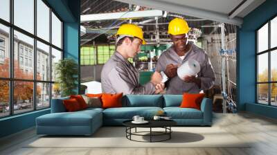 two textile workers disscussing work in factory Wall mural