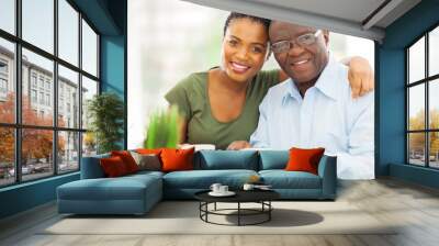 young adult african girl and father having coffee Wall mural