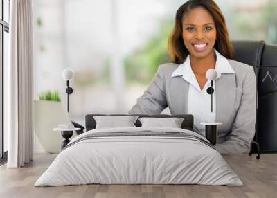 young afro american businesswoman sitting in office Wall mural