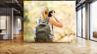 young female photographer in mountain Wall mural