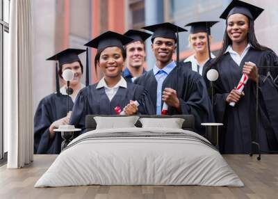 young graduates standing in front of university building Wall mural