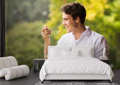 young man eating breakfast Wall mural