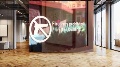 Firearms prohibited sign on the glass entrance door to establishment notifies patrons that weapons aren't allowed, and addresses security policy and protection concerns Wall mural