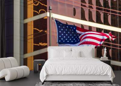 USA Flag. American flag. Flag of the United States flies waving beautifully in the strong wind. Background glass facade of modern office building Wall mural